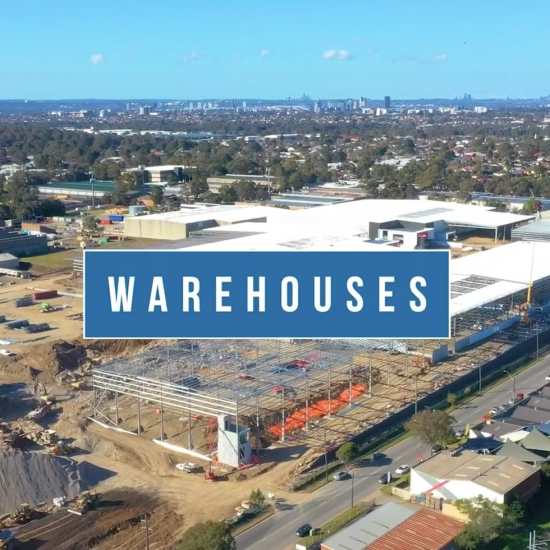 Aerial drone captures the progress of an industrial warehouse construction site.
